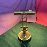 Vintage adjustable brass banker’s piano desk lamp with classic design, sturdy brass construction, and adjustable arm—perfect for desks, pianos, or reading areas.