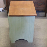 Sage green wooden nightstand with drawers and soft finish