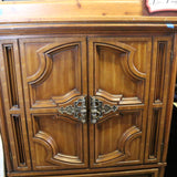 Antique wooden Bassett armoire with intricate carvings and storage compartments