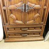 Antique wooden Bassett armoire with intricate carvings and storage compartments