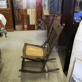 Antique oak rocking chair with caned seat and pressed back detailing