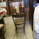 Antique oak rocking chair with caned seat and pressed back detailing