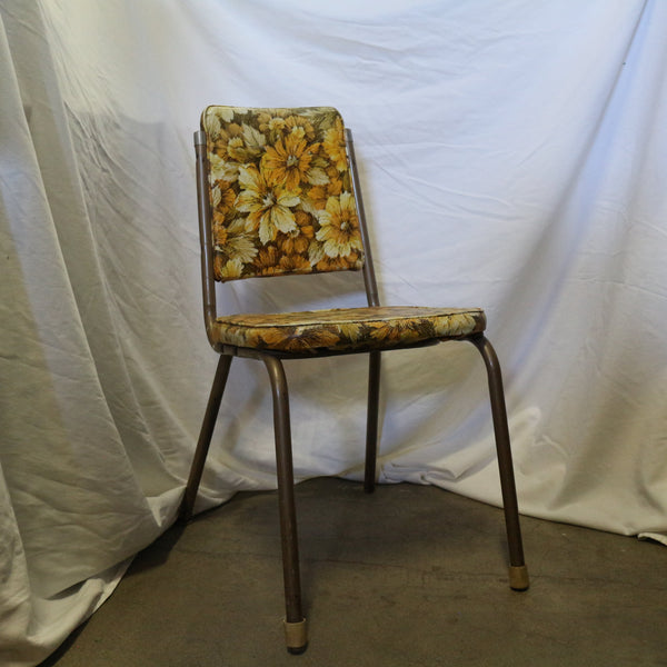 Vintage yellow floral chair with wooden frame and cushioned seat