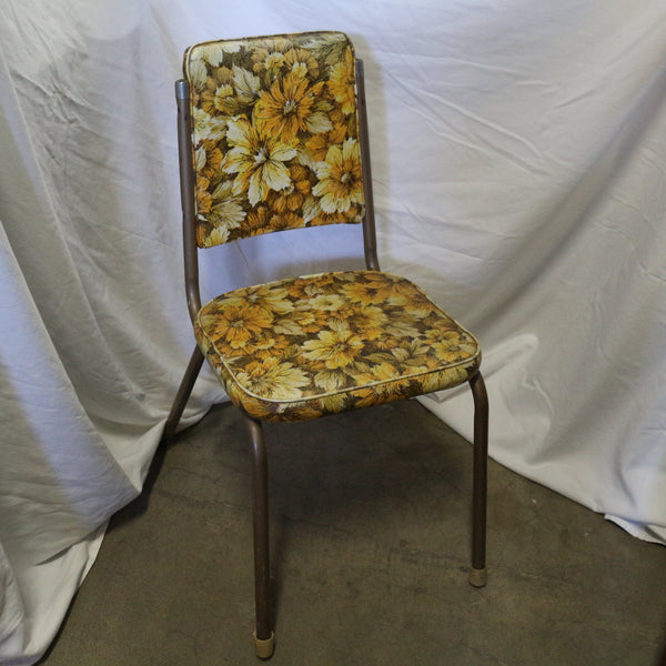 Vintage yellow floral chair with wooden frame and cushioned seat