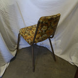 Vintage yellow floral chair with wooden frame and cushioned seat