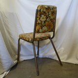 Vintage yellow floral chair with wooden frame and cushioned seat