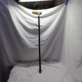 Folding walking cane with black shaft and wooden handle in used condition