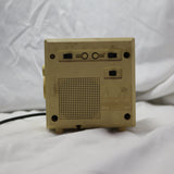 Vintage Panasonic cube clock radio with mirrored display and rotary dials, showing wear and tear.
