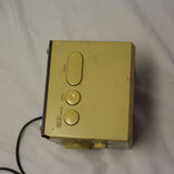 Vintage Panasonic cube clock radio with mirrored display and rotary dials, showing wear and tear.